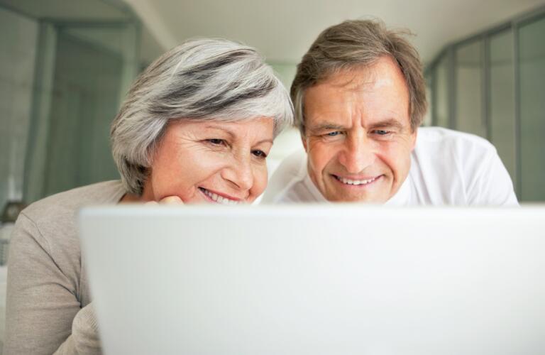 Couple viewing laptop