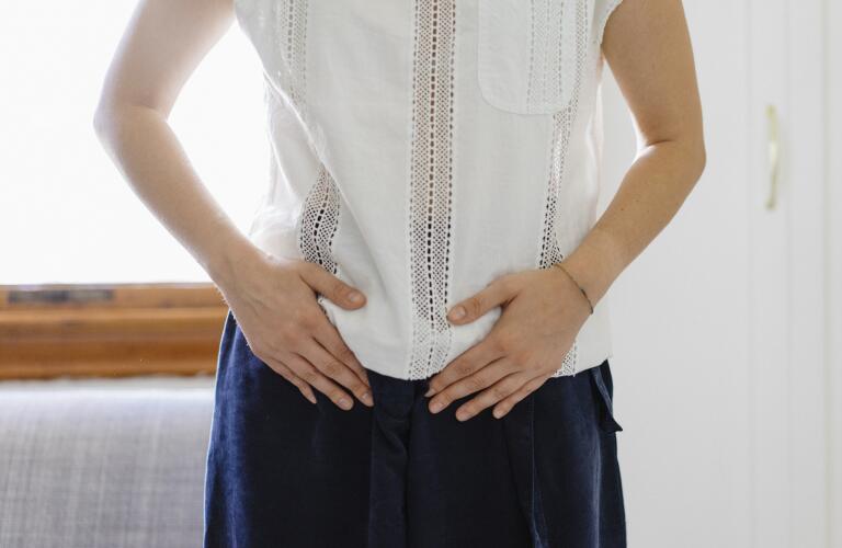 woman with hands on pelvis
