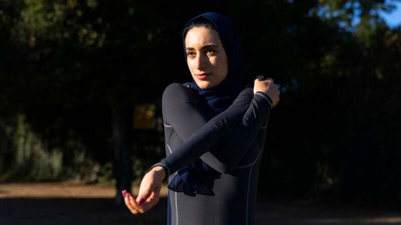 A woman stretching her left arm