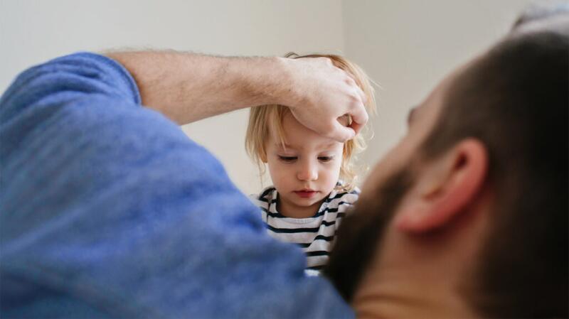 A man is comforting a young child