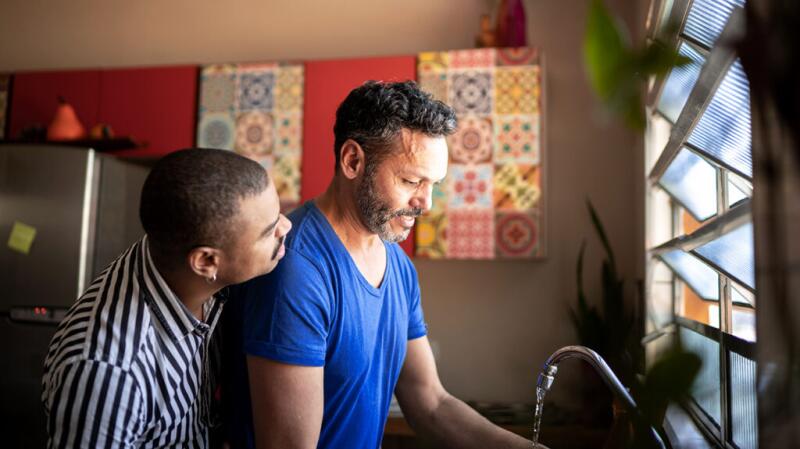 A couple in the kitchen doing dishes