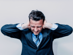 business man covering ears