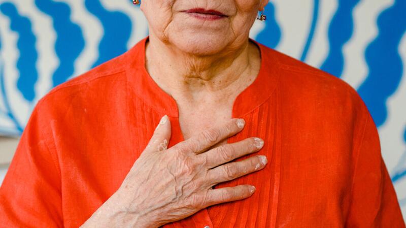 A person has their hand on their chest.