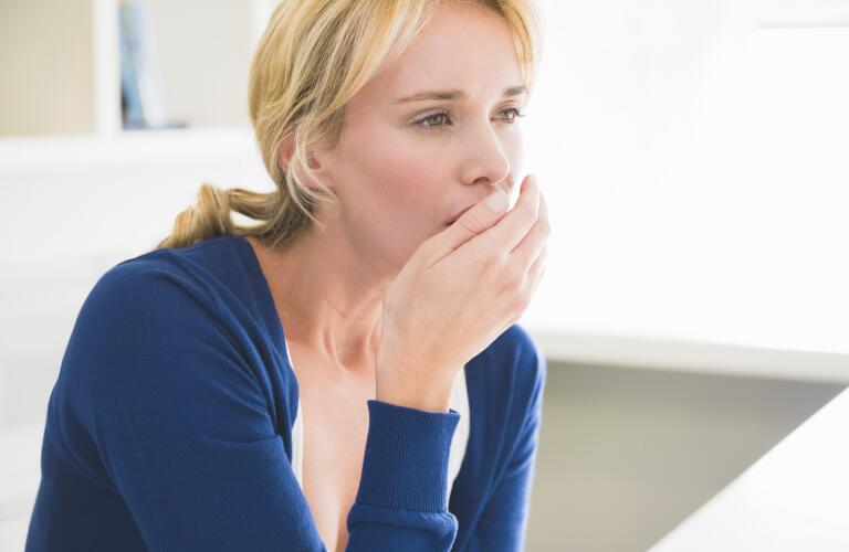 Close-up of a woman coughing