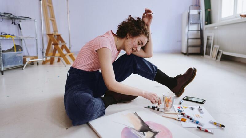 A person with acne painting