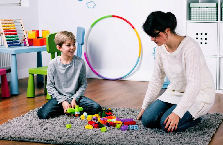 Boy playing with toys in therapy