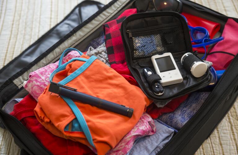 diabetes medical test devices and insulin pen in a suitcase