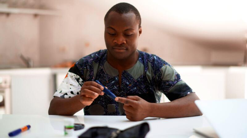 a man is checking his glucose levels