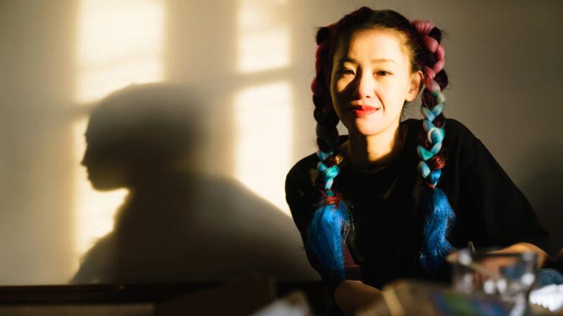 Person with colorful plaits