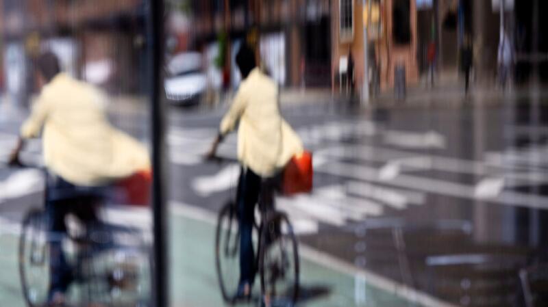 A blurry picture of a person on a bicycle
