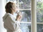 Woman Drinking Coffee Looking Out Window