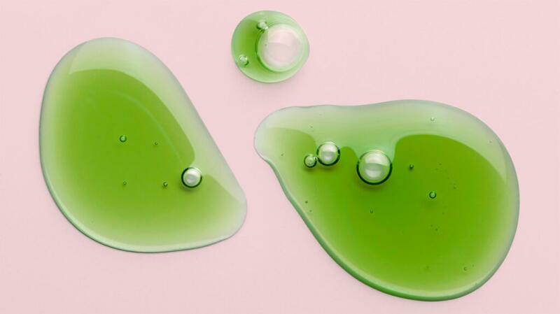 There is green liquid against a pink background.