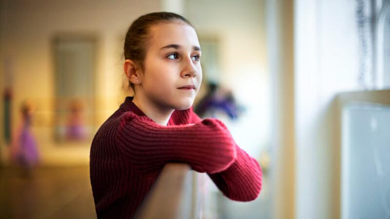A young person is looking thoughtful.