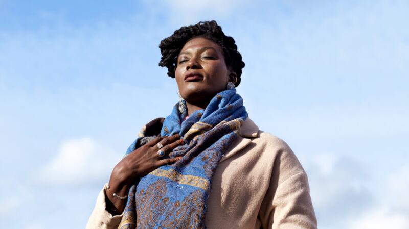 Woman with hand over chest and eyes closed