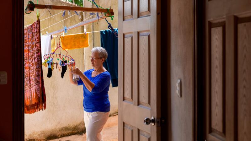 A woman is hanging laundry.