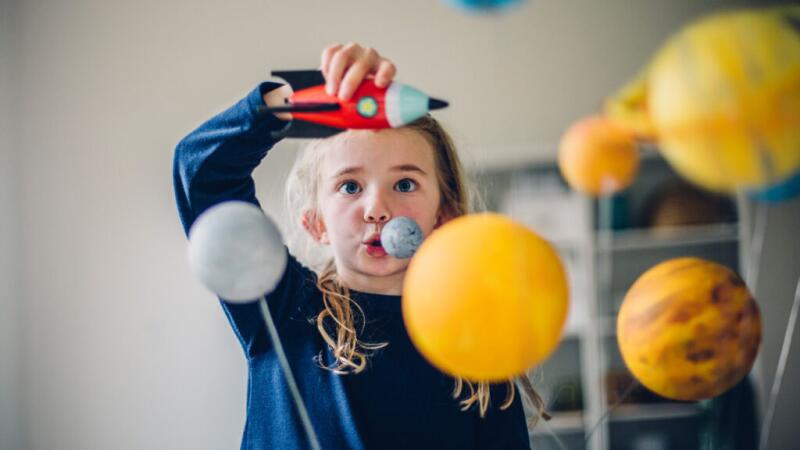child playing in a room with toys