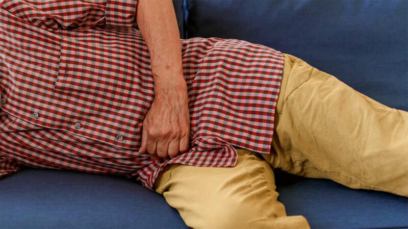 A person has a hand on their stomach.