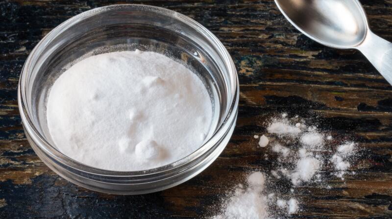high angle of baking soda and measuring spoon 