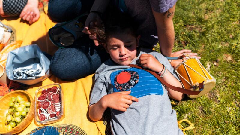 Young male child sleeping at a picnic