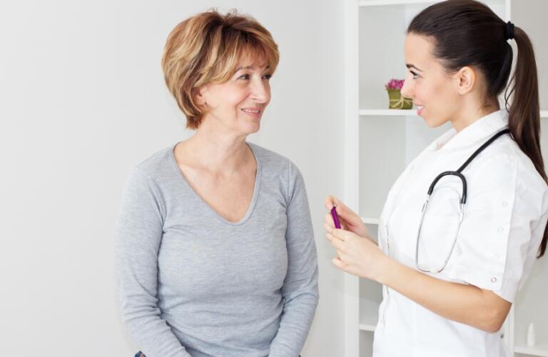 Women doctor talking with women patient