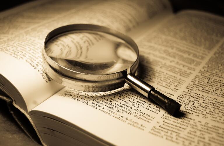 magnifying-glass-on-open-book