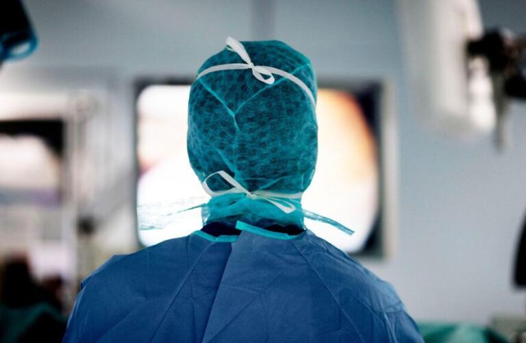 A surgeon stands ready in an operating room