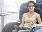 woman sitting in infusion chair with tablet