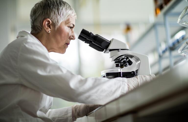 doctor-looking-through-microscope