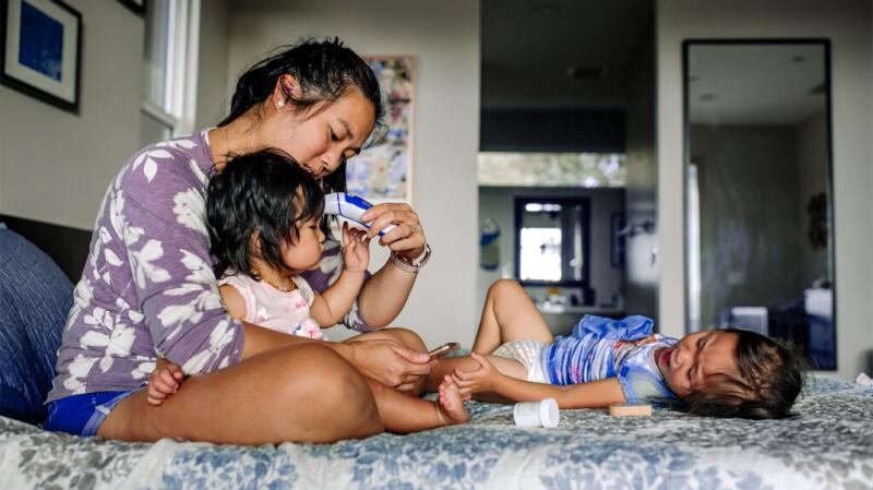 mother taking child's temperature