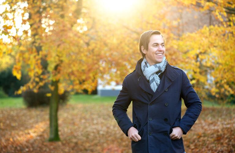 man-smiling-outdoors-on-autumn-day