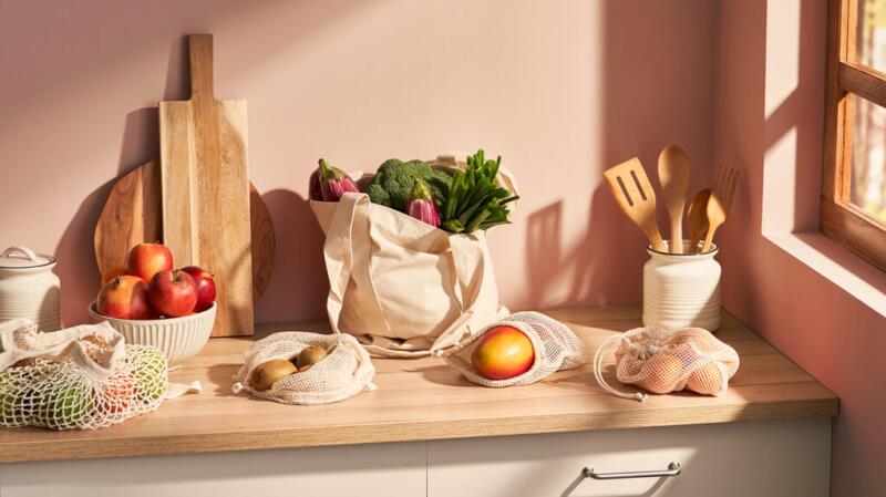 A variety of fruits and vegetables on a kitchen counter