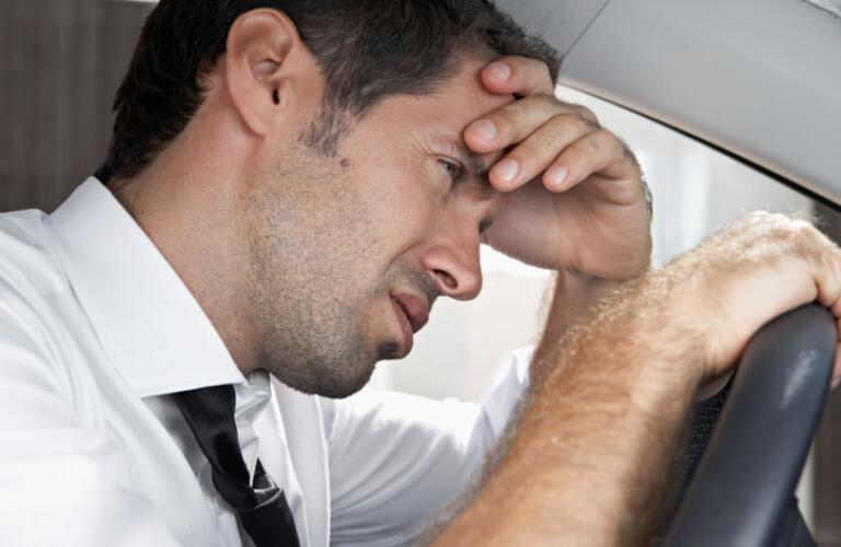 Man looking sick in car
