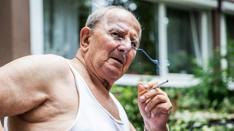 An older man smoking