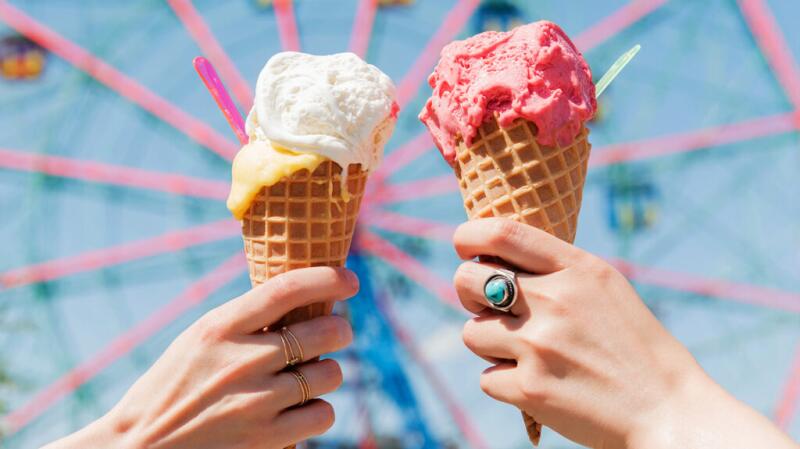 There is a closeup of two ice cream cones.
