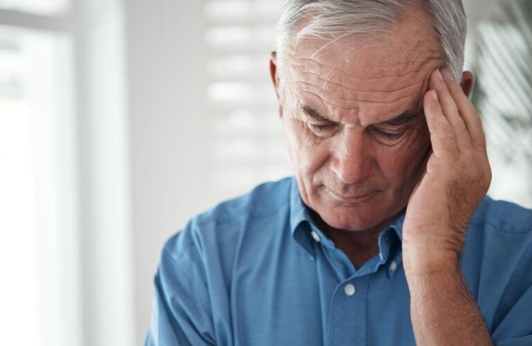 senior-male-with-hand-on-head