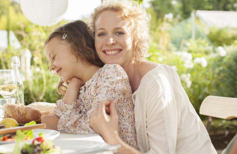 smiling-woman-with-daughter-outside