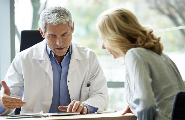doctor talking to female patient