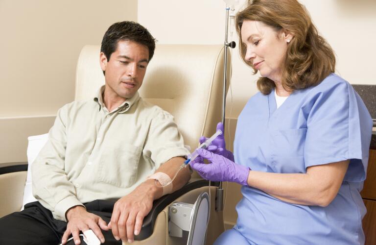 Nurse Giving Patient Injection Through Tube