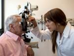female eye doctor examining eyes of patient