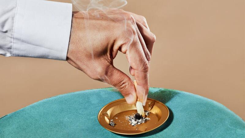 A hand putting out a cigarette