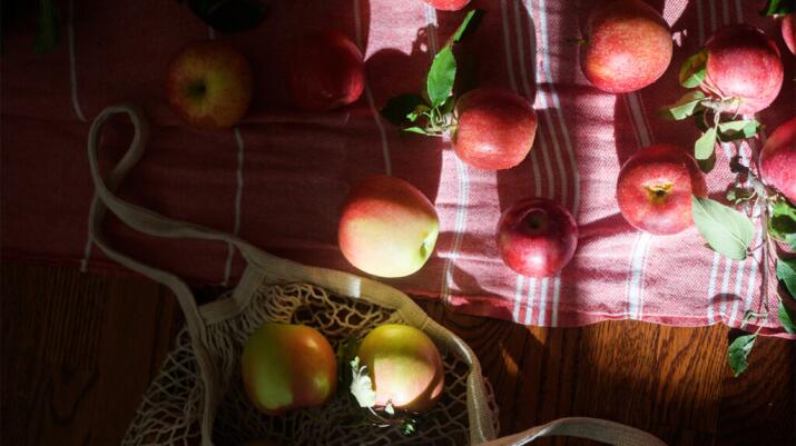 there are apples on a table, which can help ease nausea