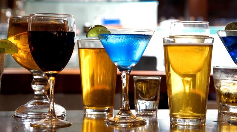 mixture of wine, liquor, beer glasses on bar