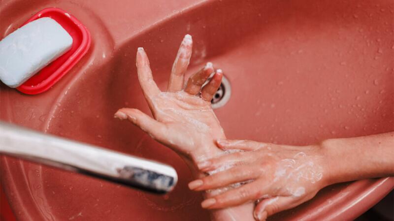Close up of person washing hands