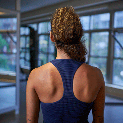 a woman is doing a shoulder blade squeeze