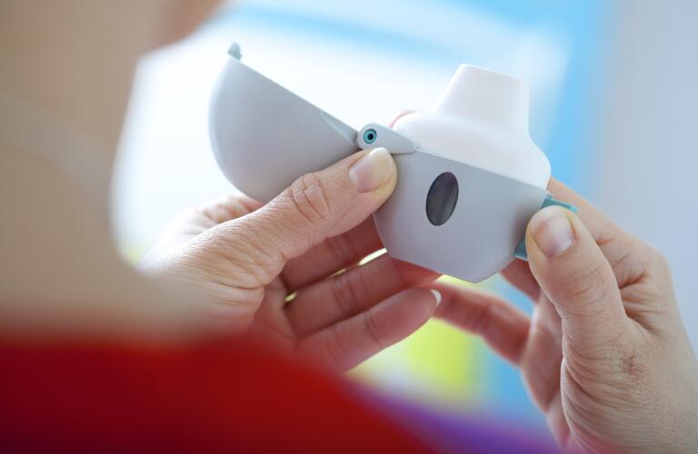 unidentifiable woman's hands holding a COPD treatment (bronchodilator)