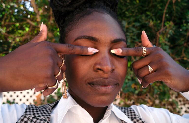 Woman covering eyes with forefingers