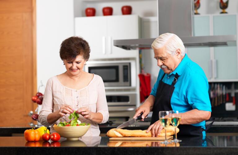 middle aged couple preparing dinner
