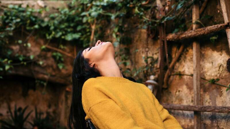 a person is wearing a yellow sweater