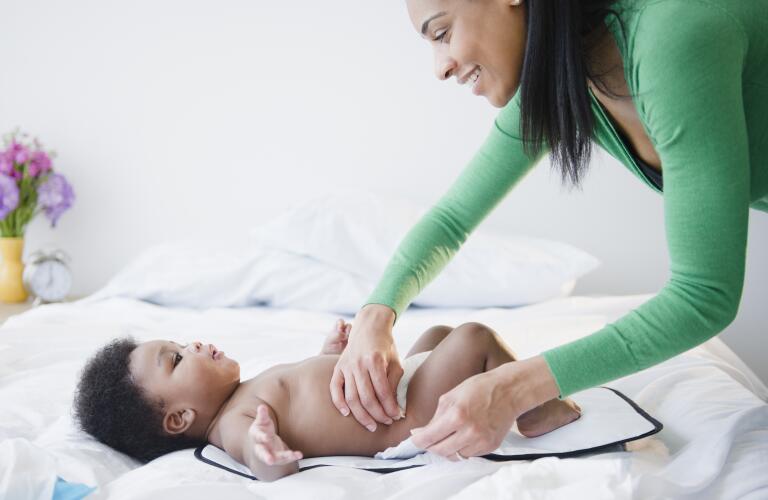 mother-changing-babys-diaper