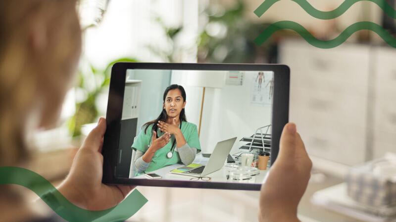 A person is talking with a doctor on a tablet device.